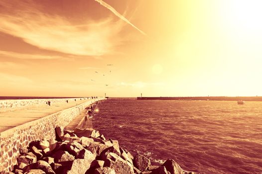 Summer. Warm red summer over sea with jetty.