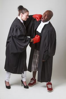 woman and man in canadian lawyer toga having a boxing match