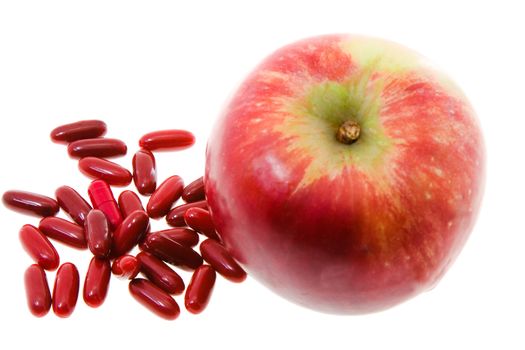 Red Apple and red pill, medicine, isolated on white