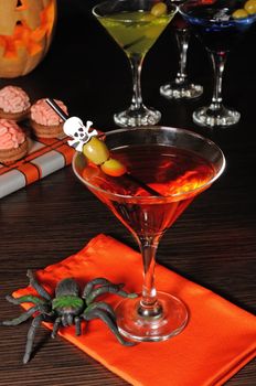 Cocktail with olives straw decorated with a skull