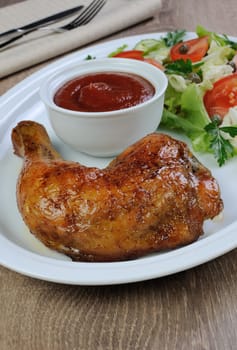 Baked chicken thigh with sauce and salad