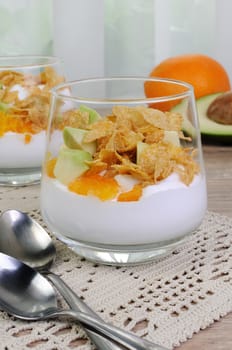 Parfait with slices of orange, avocado and flakes