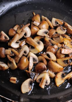 Fried sliced mushrooms in butter in a frying pan. For step by step recipe