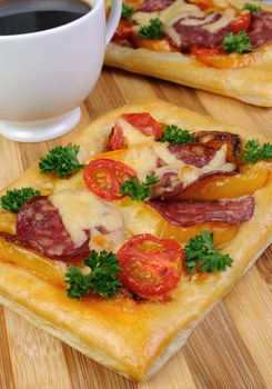 Mini pizza with vegetables, salami and cheese