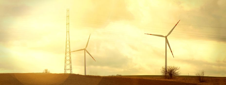 Windmills on the field. Vintage instagram picture. Alternative energy.