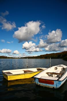 Colorful boats on a lake with cloudy blue sky in Denmark