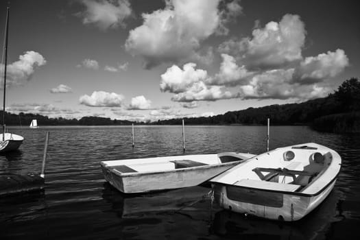 Colorful boats on a lake with cloudy blue sky in Denmark