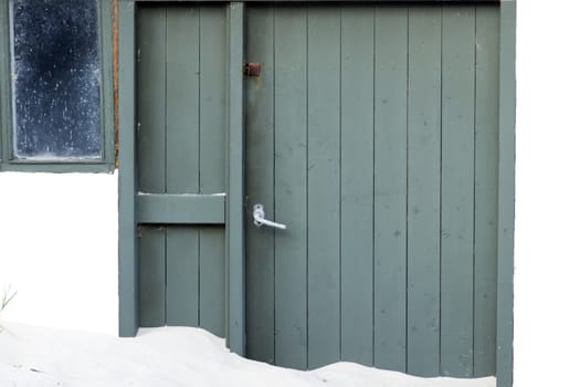 Green door of beach house in denmark