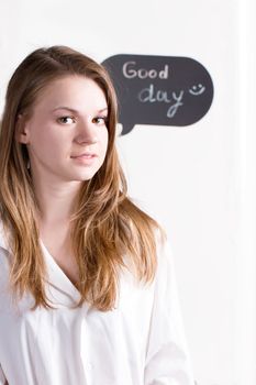 Girl in a white shirt on the background of the inscription a good day