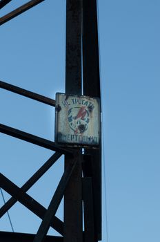 supports of high-voltage power lines against the blue sky