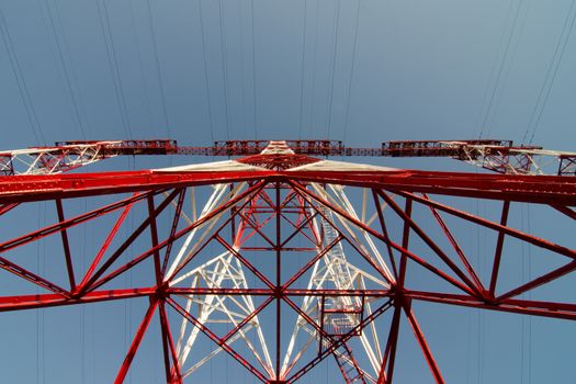 supports of high-voltage power lines against the blue sky