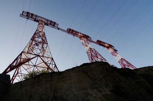 supports of high-voltage power lines against the blue sky