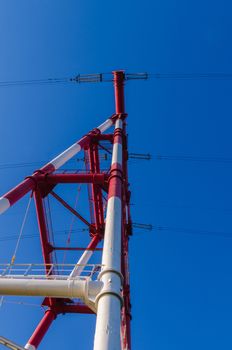 supports of high-voltage power lines against the blue sky