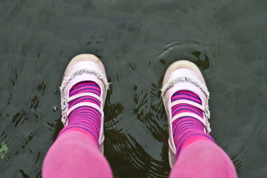 Cute pink legs of a child sitting