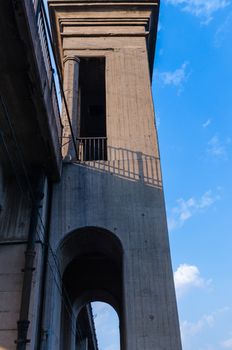 road and rail split-level bridge over the river on a background of blue sky in the city