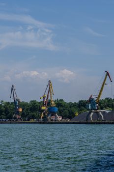 cargo port with cargo cranes on a blue sky background