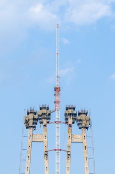 the construction of a bridge across the river with the supports, structural elements, cranes