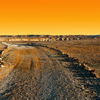 Dirt Road in the Rocky Hills of the Negev Desert in Israel at Sunset