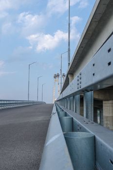 the construction of a bridge across the river with the supports, structural elements, cranes