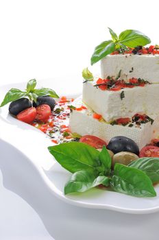 Pieces of feta   with basil and olives, cherry tomatoes