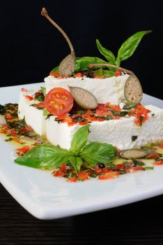 Pieces of feta   with basil and olives, cherry tomatoes