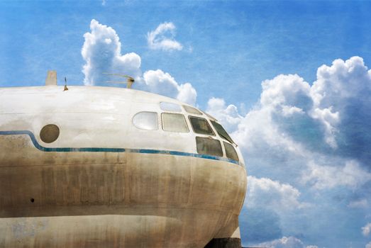 Military transport plane, blue sky background Photo textured in old color image style.