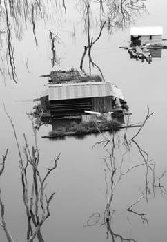 Vietnam landscape in evening on black and white, group of floating house on Nam Ka lake, dry tree reflect on water make amazing scene of Asia countryside