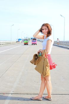 Beautiful young lady and happy on the bridge