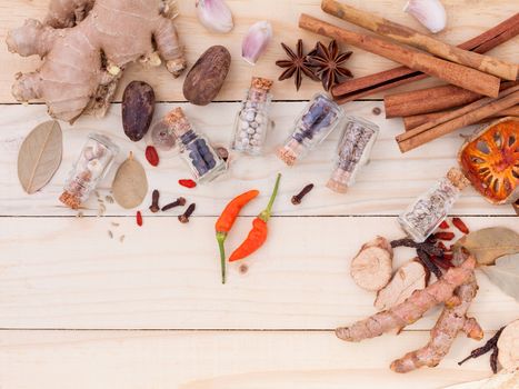 Assortment of Thai food Cooking ingredients in glass bottles on wooden background.