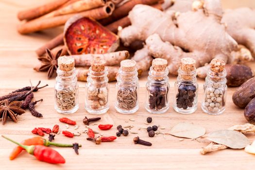 Assortment of Thai food Cooking ingredients in glass bottles on wooden background.