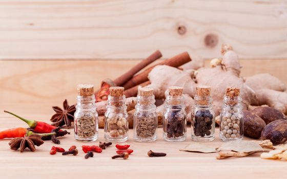 Assortment of Thai food Cooking ingredients in glass bottles on wooden background.