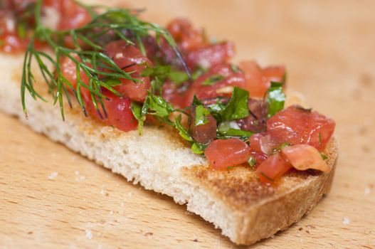 Italian bruschetta topped with tomatoes and dill