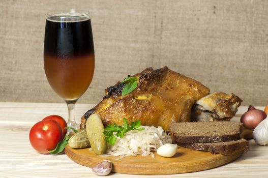 Roasted pork leg (rulka) served with sauerkraut, pickled cucumber, rye bread and sliced (rezane) beer