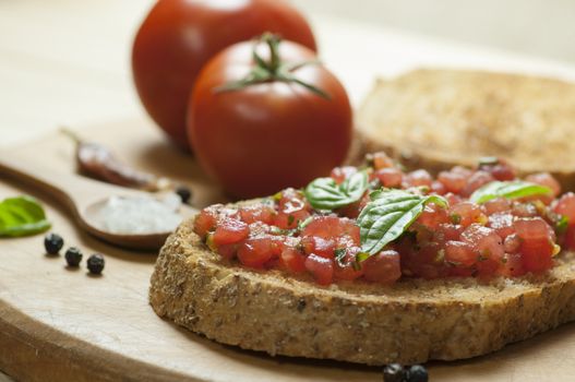 Italian bruschetta topped with tomatoes and basil