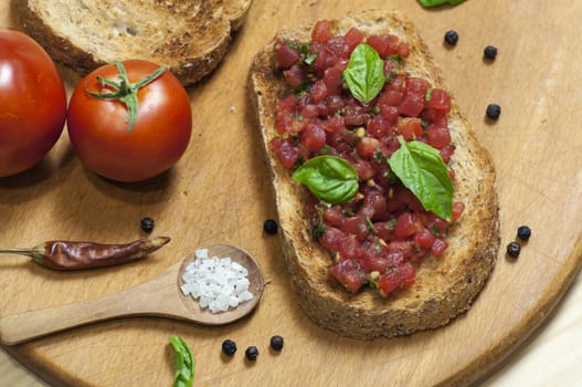 Italian bruschetta topped with tomatoes and basil, view from above