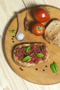 Italian bruschetta topped with tomatoes and basil, view from above