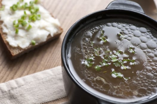 Mushroom soup served with lard spread on rye bread with green onion view from above