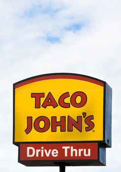 GRINNELL, IA/USA - AUGUST 8, 2015: Taco John's exterior and sign. Taco John's is fast-food restaurant featuring Mexican-inspired fast-food.