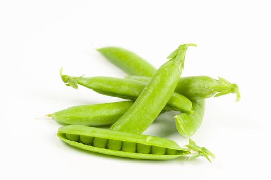 Ripe green organic peas in the pod isolated on white