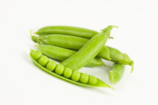 Ripe green organic peas in the pod isolated on white