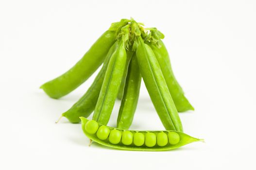 Ripe green organic peas in the pod isolated on white