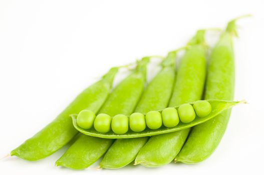 Ripe green organic peas in the pod isolated on white