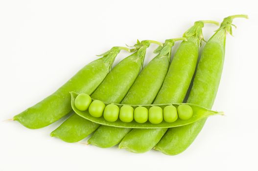 Ripe green organic peas in the pod isolated on white