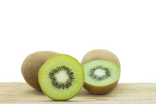 Fresh kiwis on wooden ground  isolated on white background