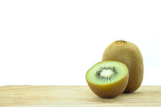 Fresh kiwis on wooden ground  isolated on white background