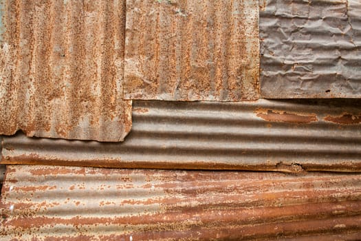 A rusty corrugated iron metal fence close up/ Zinc wall