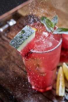 Homemade watermelon lemonade with mint and lemon in glasses and slices of watermelon