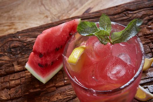 Homemade watermelon lemonade with mint and lemon in glasses and slices of watermelon