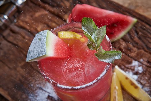 Homemade watermelon lemonade with mint and lemon in glasses and slices of watermelon