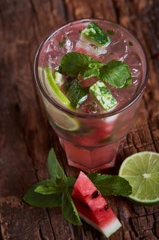 Homemade watermelon lemonade with mint and lime in glasses and slices of watermelon
